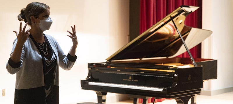 photo of woman with piano in background