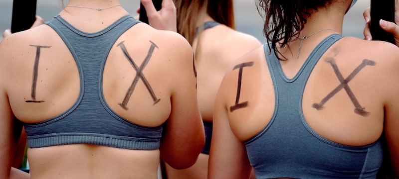 photo of women with I X written on their backs