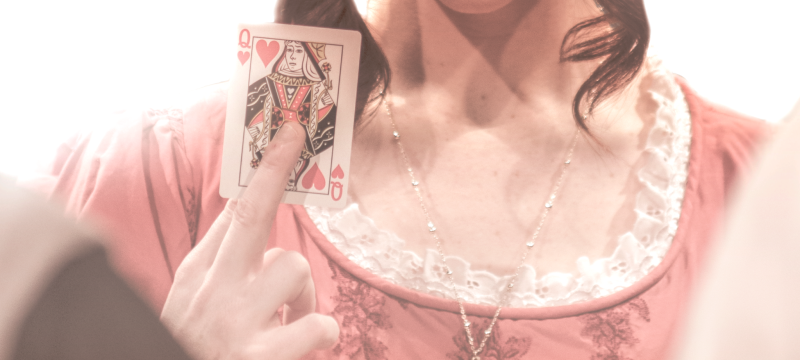 promo photo of woman holding playing card