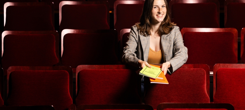 photo of woman sitting in theatre seats