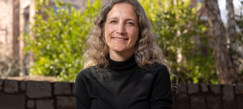 photo of woman, outdoors, with wall