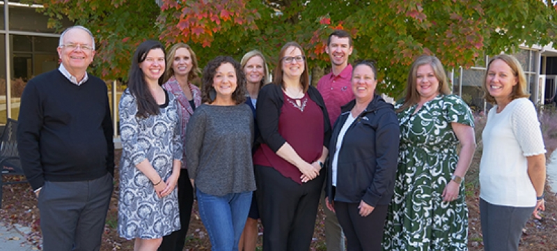 group photo of people, trees in background