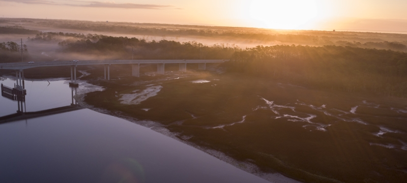 aerial photo of a coastal marsh, with bridge