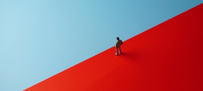 graphic with semaphore color field of blue and red, human figure at center