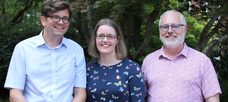 photo of three people, outdoors