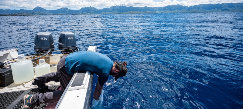 photo of man in boat in the ocean