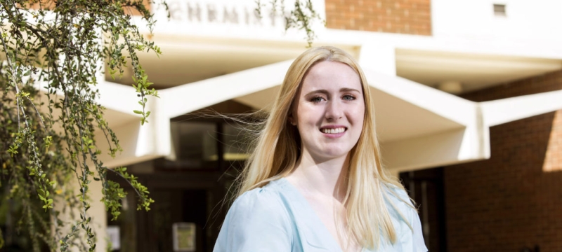 photo of woman in front of building, day
