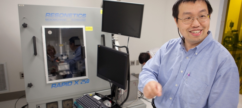 photo of man with computer and diagnostic machine