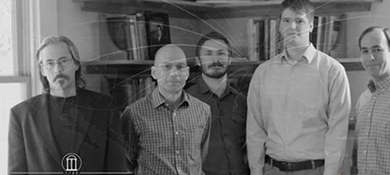 b/w photo of five men, with logos