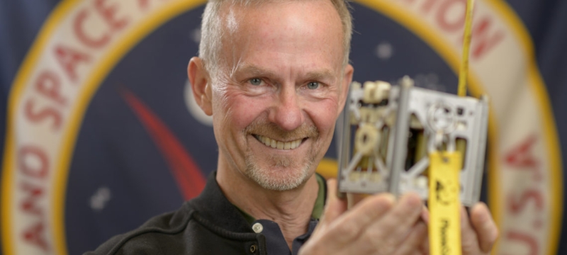 photo of man holding a phonesat