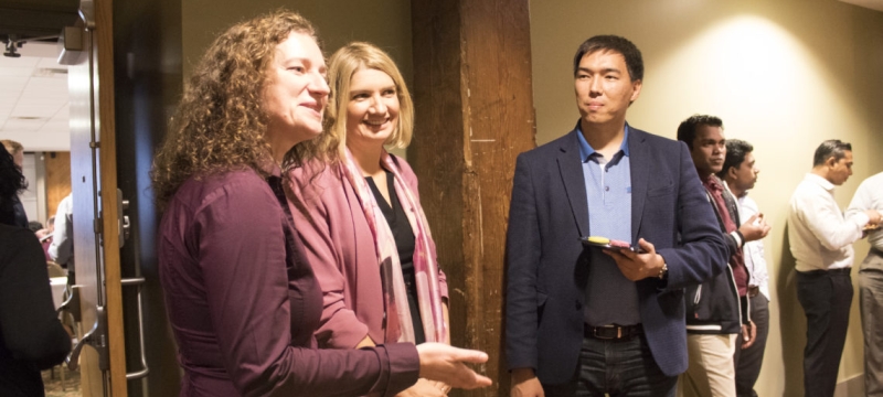 photo of several people speaking at an event