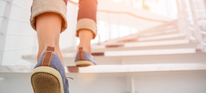 photo of shoes and legs on stairs