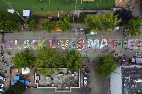 aerial photo of street with Black Lives Matter written on pavement