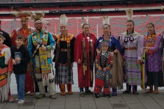 photo of Native Americans in indigenous dress at stadium