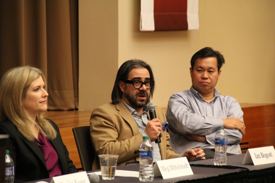 photo of three people, one holding microphone