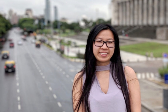 photo of woman outdoors on bridge over highway