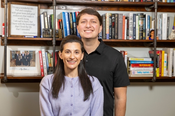 photo of man and woman, bookshelves in background