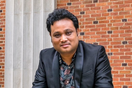 photo of man with brick building background