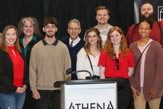 group photo of people behind podium