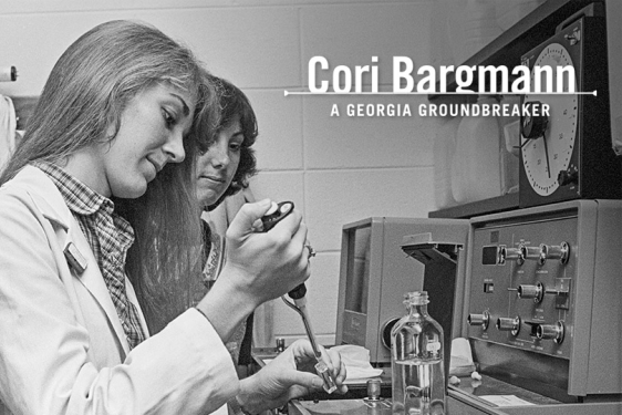 black and white photo of two people in a lab, woman in foreground 