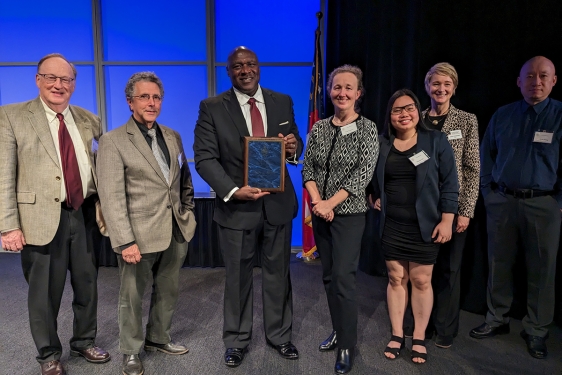 group photo of seven people on stage