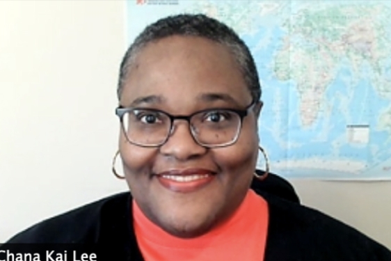 photo of woman, with wall map in background
