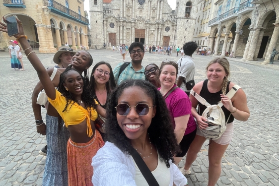 photo of group of people, classical architecture in background, day