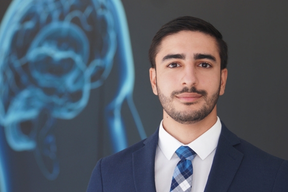 photo of man with design on screen in background