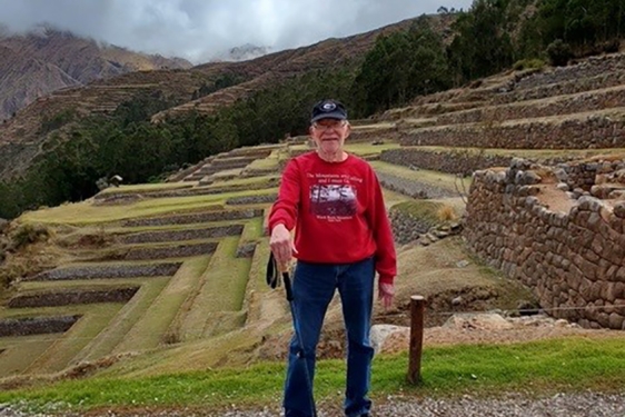 photo of man, ancient terraces in background, day