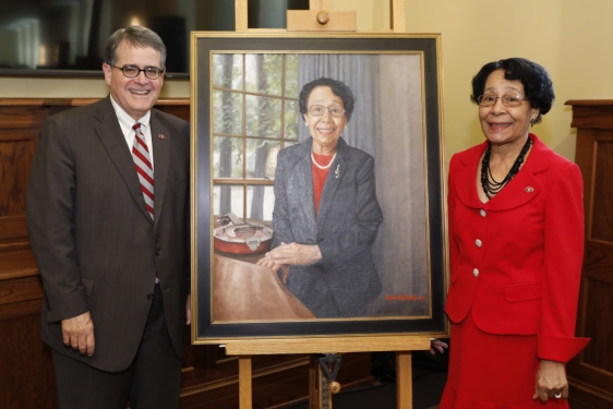 photo of two people with a painted portrait