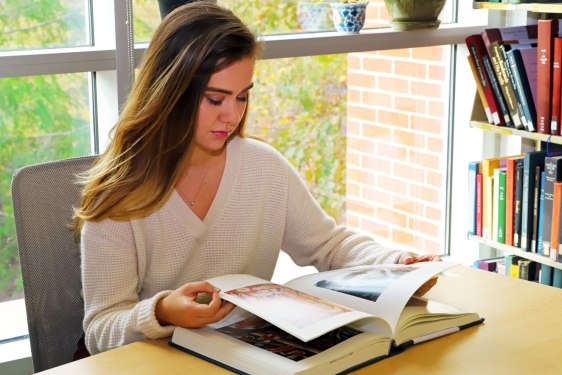 photo of woman with book
