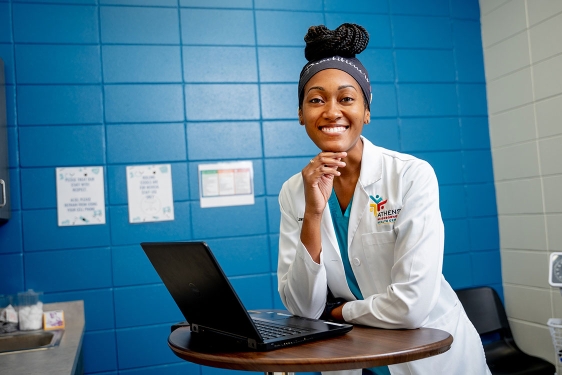 photo of woman with laptop in exam room