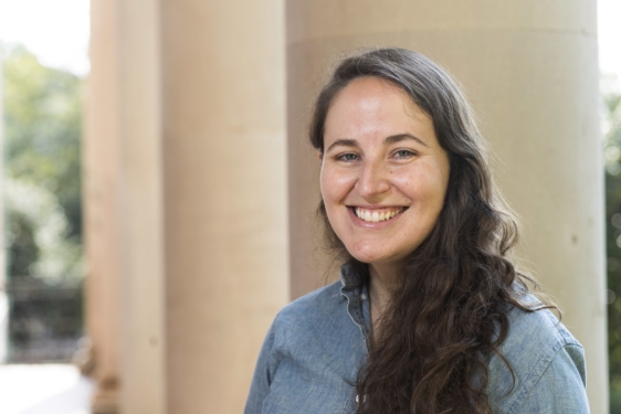 photo of a woman in front of a column