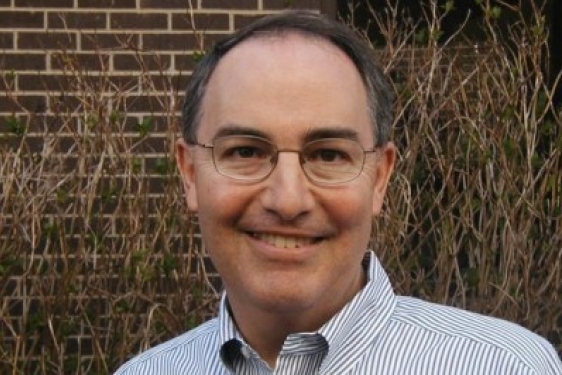 headshot photo of man, outdoors