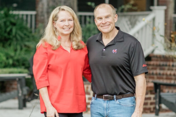 photo of two people, outdoors, steps and porch in background