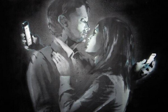 photo of graffiti drawing of couple looking at smartphones
