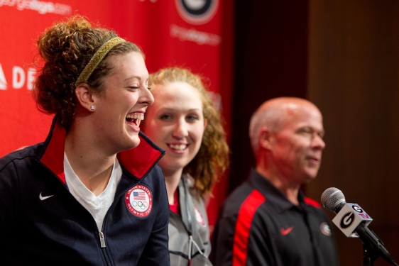photo of two woman and man, with microphone