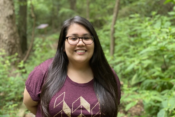 photo of woman outdoors, trees in background