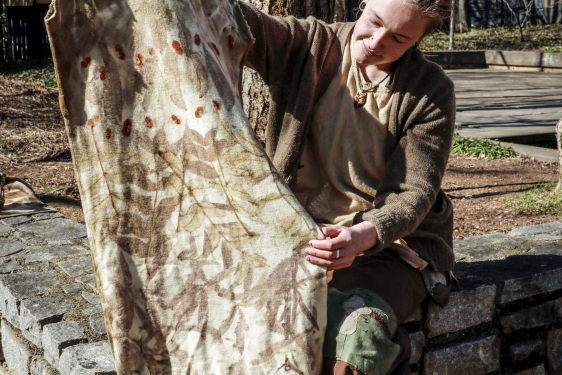 pho too woman holding eco-print fabric, outside, day