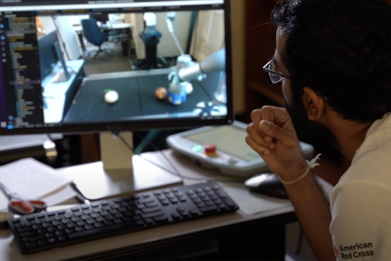 video still image of man looking at computer screen