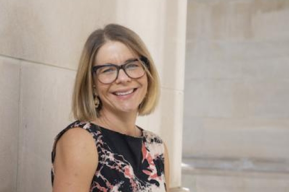 photo of woman, outdoors, with building