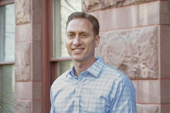 photo of man, building in background