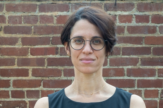 photo of woman, brick wall in background
