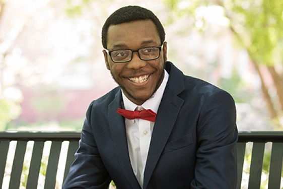 man in suit, seated, outside