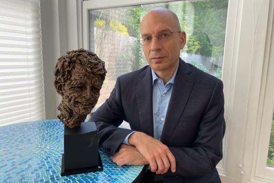 photo of man with bust sculpture