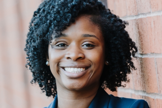 headshot of photo woman, with wall