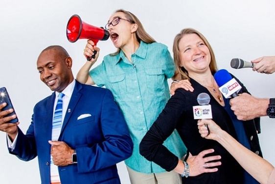 photo of man and two women, microphones, 