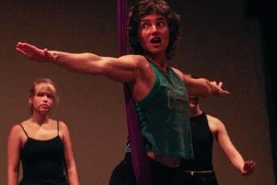 photo of woman arms extended, with two people in background