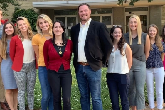 group photo of men and woman outdoors