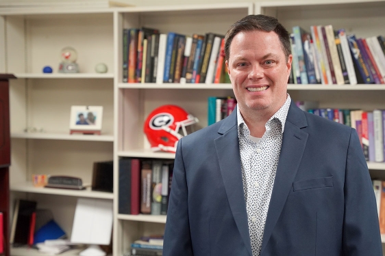 photo of man, bookshelves background